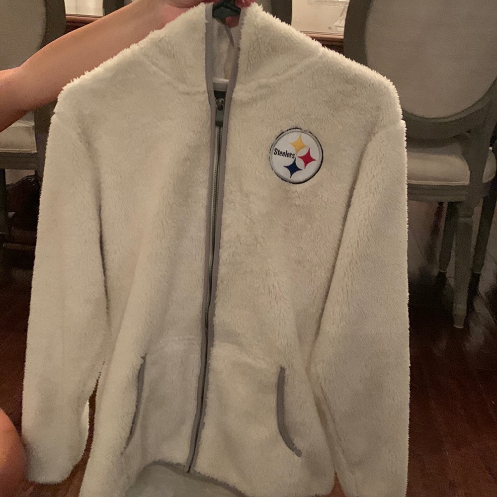 NFL STEELERS Zip Up Jacket with hood. Never worn. Logo on front and back.